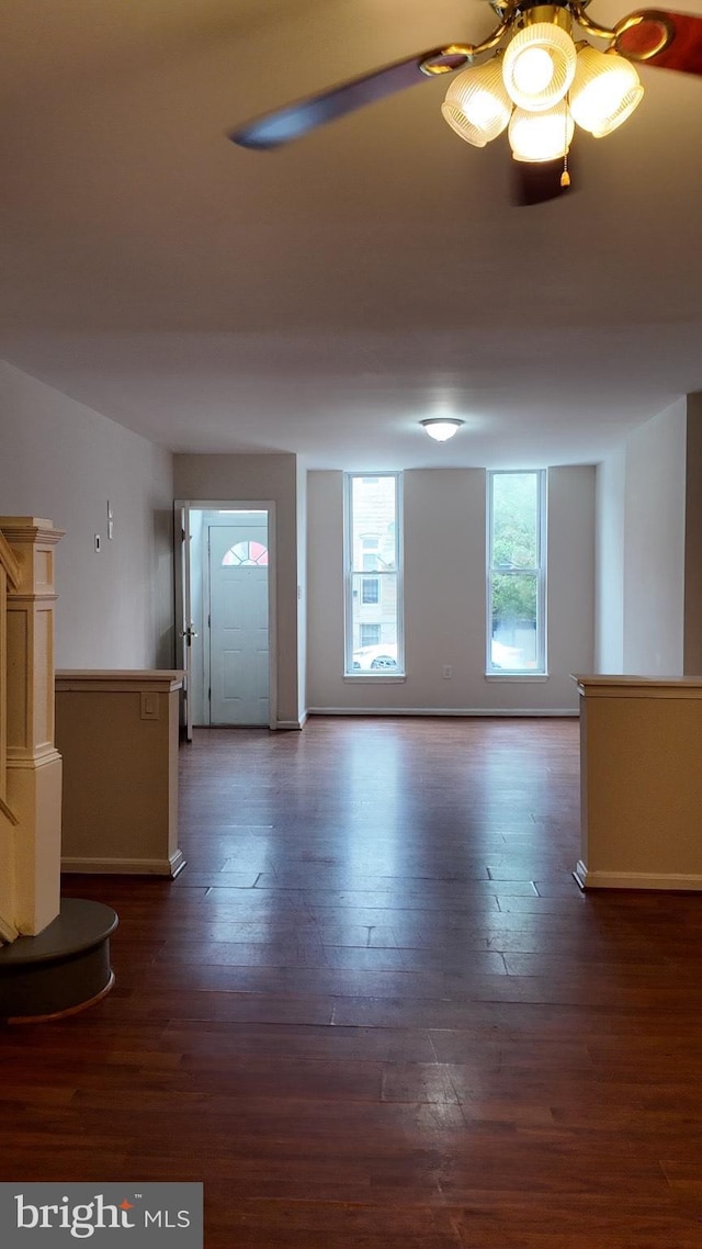 interior space with dark wood-style flooring and baseboards