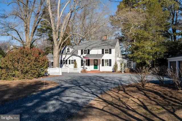 view of front of home featuring fence and a chimney