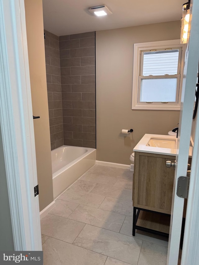 bathroom with baseboards, shower / bathing tub combination, vanity, and toilet