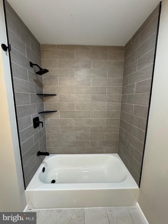 full bathroom with bathing tub / shower combination and baseboards