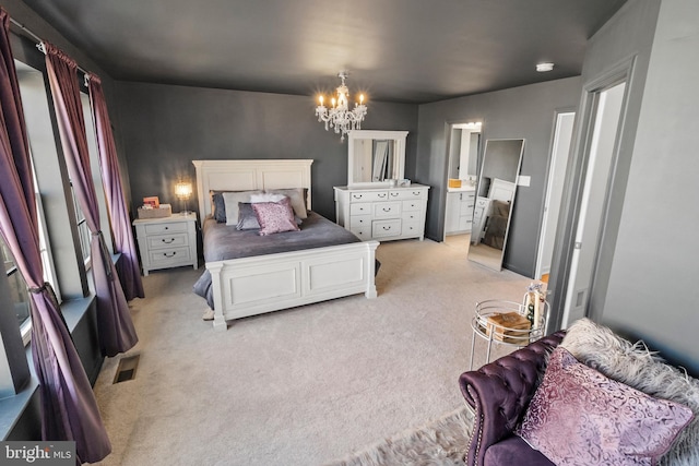 bedroom with a chandelier, light colored carpet, connected bathroom, and visible vents