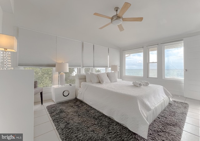 bedroom featuring light tile patterned floors, ceiling fan, and multiple windows