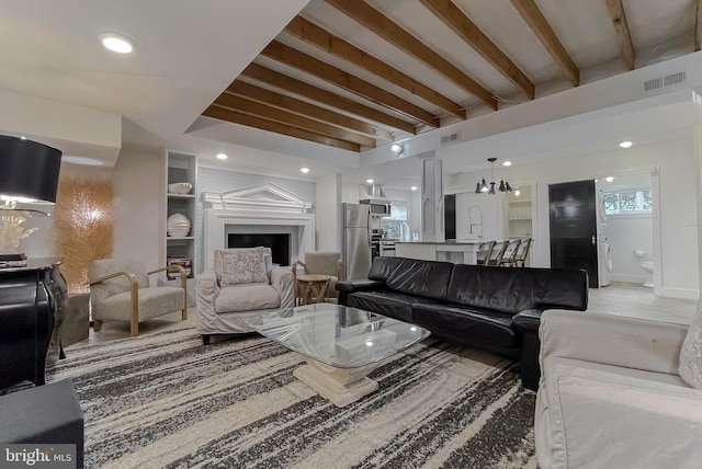 living room featuring visible vents, beamed ceiling, and recessed lighting