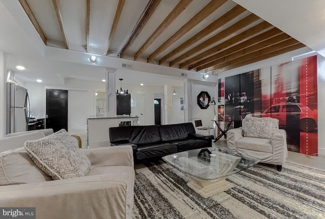 living area with visible vents and beam ceiling