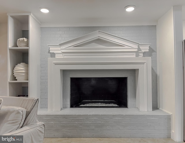 interior details with built in shelves, a fireplace, ornamental molding, and recessed lighting