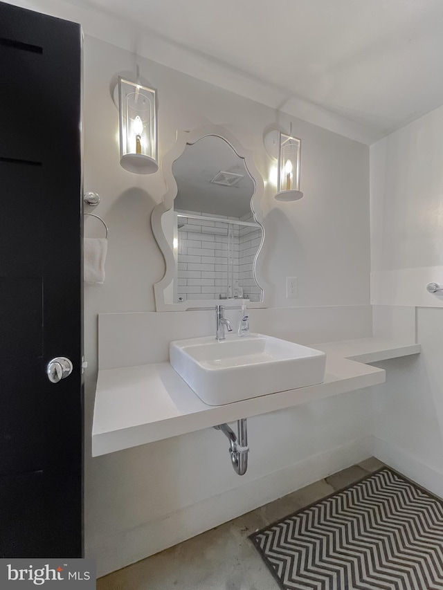 bathroom featuring visible vents and a sink