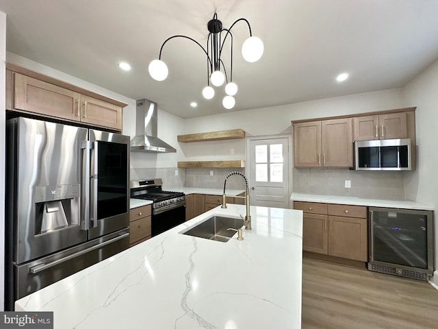 kitchen featuring beverage cooler, appliances with stainless steel finishes, pendant lighting, wall chimney range hood, and open shelves