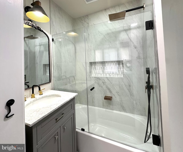 bathroom with combined bath / shower with glass door and vanity