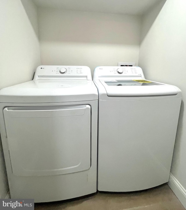 washroom featuring laundry area and washing machine and clothes dryer