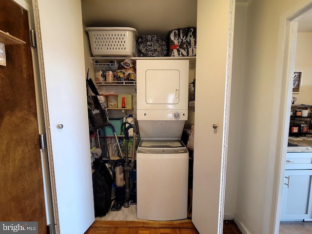 clothes washing area with laundry area and stacked washer / drying machine