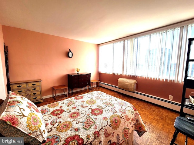 bedroom with a baseboard heating unit and baseboards