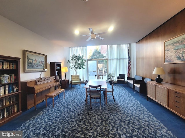 interior space with a wall of windows and a ceiling fan