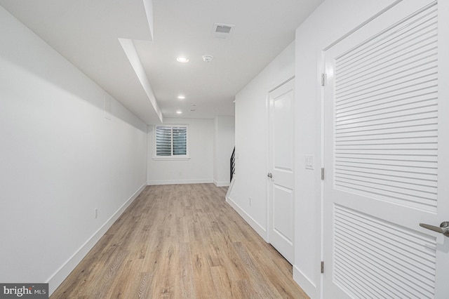 hall with visible vents, recessed lighting, light wood-style floors, and baseboards