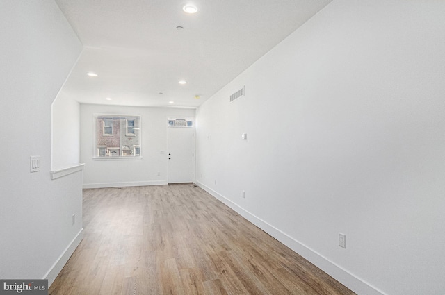 interior space featuring light wood-type flooring, visible vents, baseboards, and recessed lighting