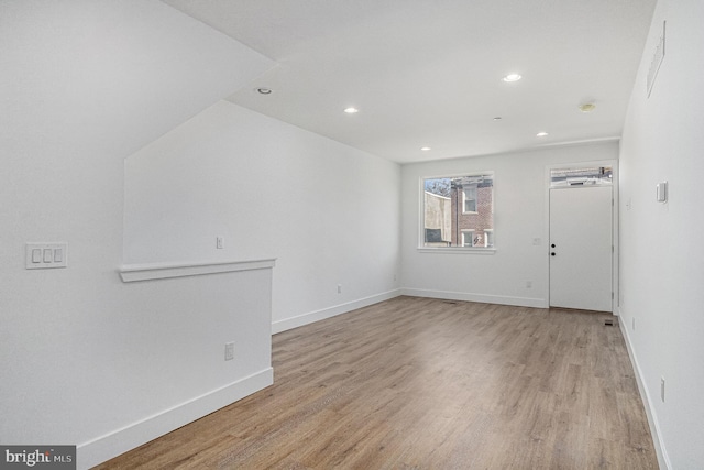 unfurnished room featuring recessed lighting, light wood-style floors, and baseboards