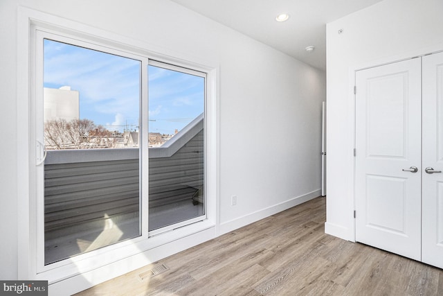 interior space featuring visible vents, recessed lighting, wood finished floors, and baseboards