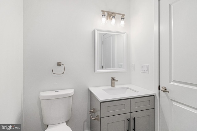 bathroom featuring toilet and vanity