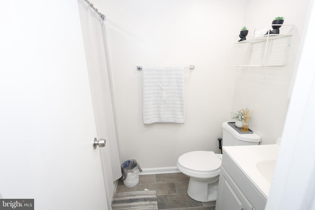 full bath with baseboards, vanity, and toilet