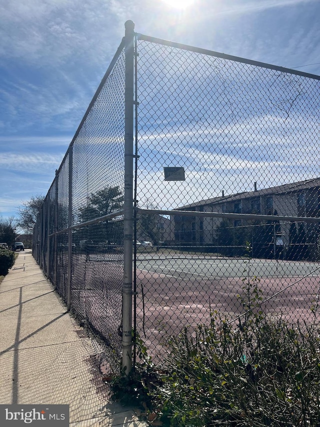 view of sport court with fence