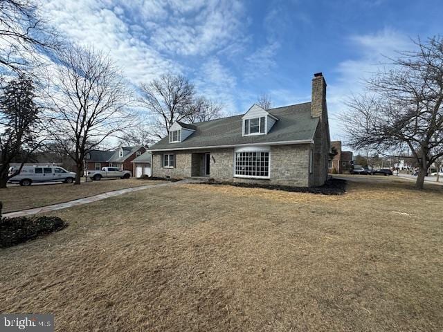 view of front of home featuring a front lawn and a chimney