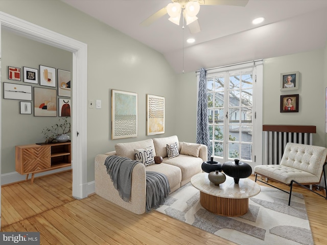 living area featuring baseboards, ceiling fan, wood-type flooring, vaulted ceiling, and recessed lighting