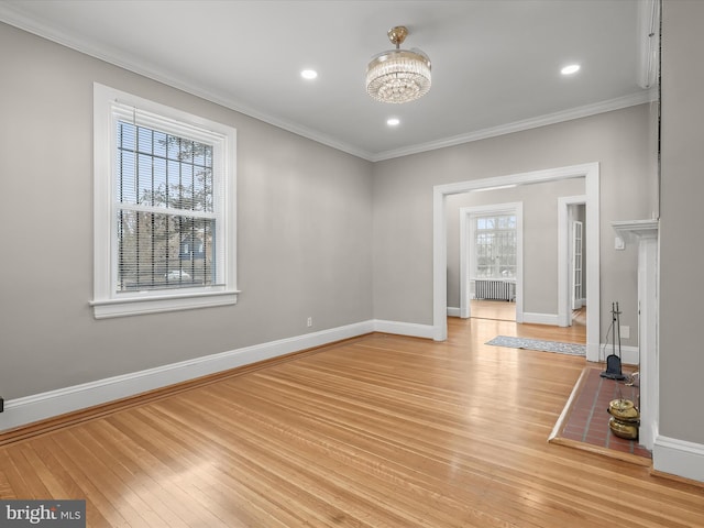 empty room featuring ornamental molding, recessed lighting, light wood-style flooring, and baseboards