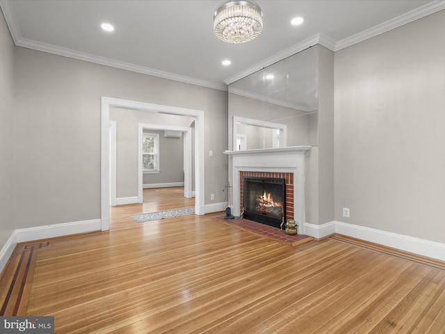 unfurnished living room with crown molding, baseboards, and wood finished floors