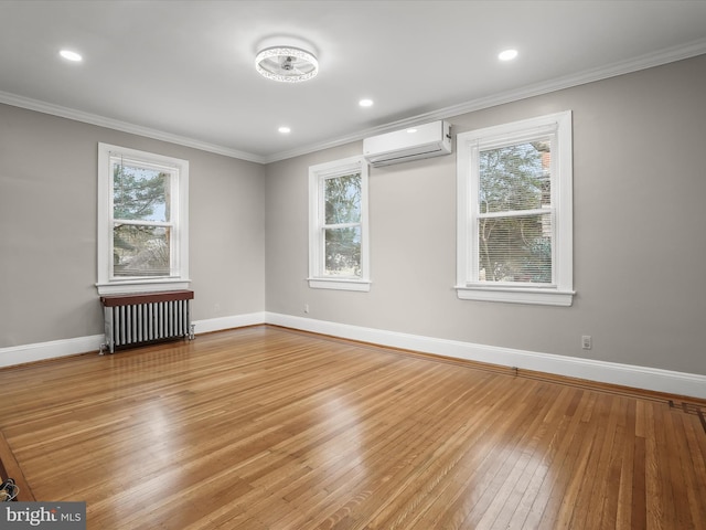 unfurnished room featuring plenty of natural light, baseboards, radiator heating unit, ornamental molding, and a wall mounted air conditioner