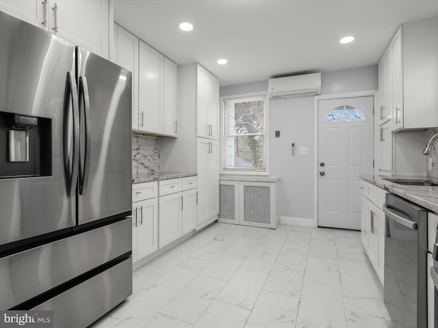 kitchen featuring white cabinets, a wall mounted air conditioner, marble finish floor, stainless steel appliances, and a sink