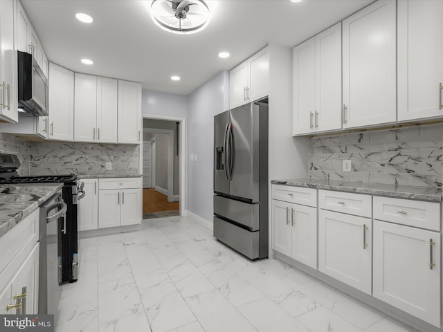 kitchen featuring marble finish floor, white cabinetry, range, and stainless steel fridge with ice dispenser