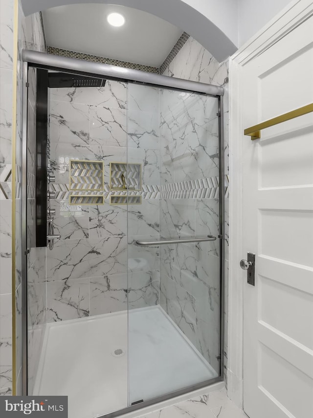 bathroom featuring marble finish floor and a marble finish shower