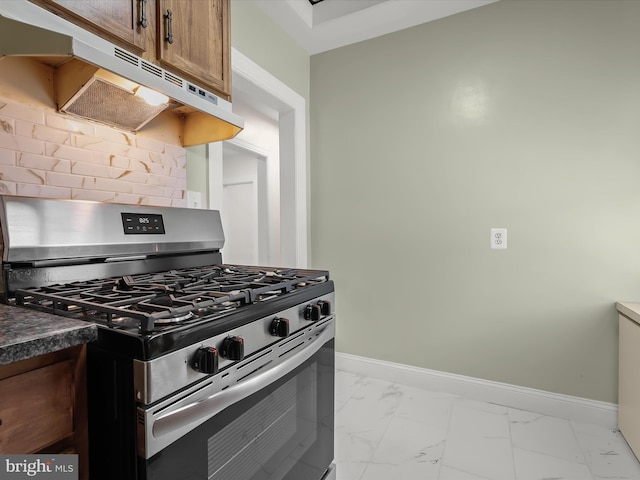 kitchen with marble finish floor, baseboards, and stainless steel range with gas stovetop