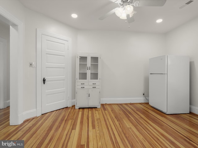 interior space featuring light wood-style flooring, recessed lighting, visible vents, and baseboards