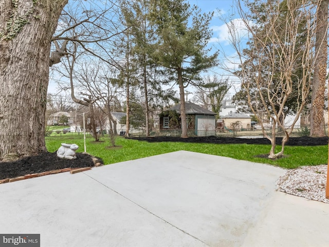 view of front of house with a patio, a front yard, and fence