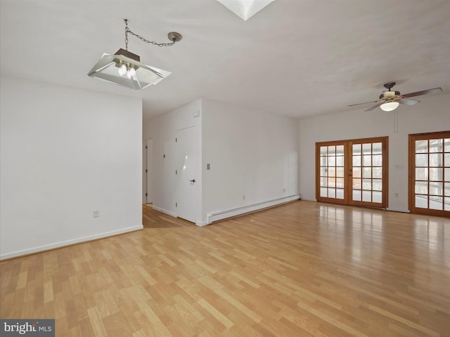 unfurnished living room featuring light wood finished floors, baseboards, a baseboard radiator, ceiling fan, and french doors