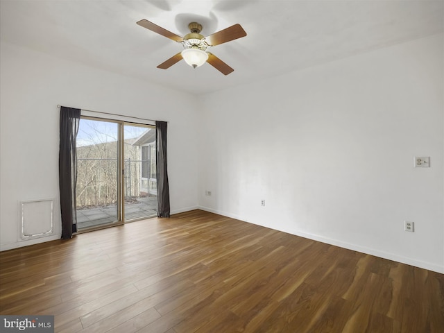 spare room featuring ceiling fan, baseboards, and wood finished floors