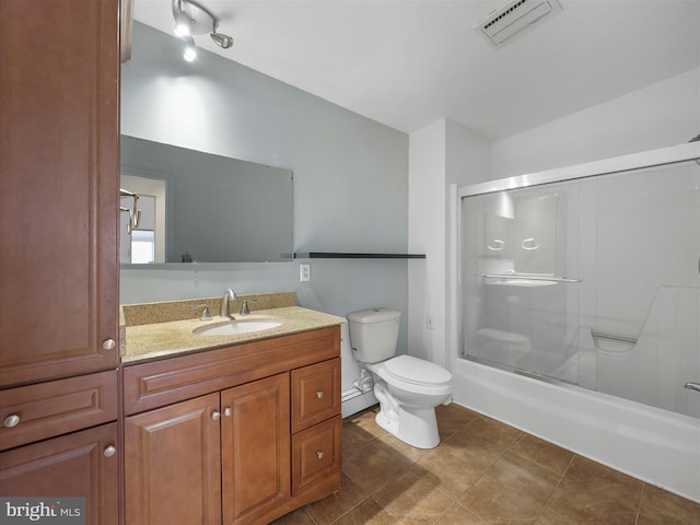 full bathroom with visible vents, toilet, combined bath / shower with glass door, vanity, and tile patterned floors