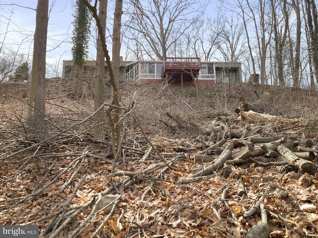 view of yard with a sunroom and a deck