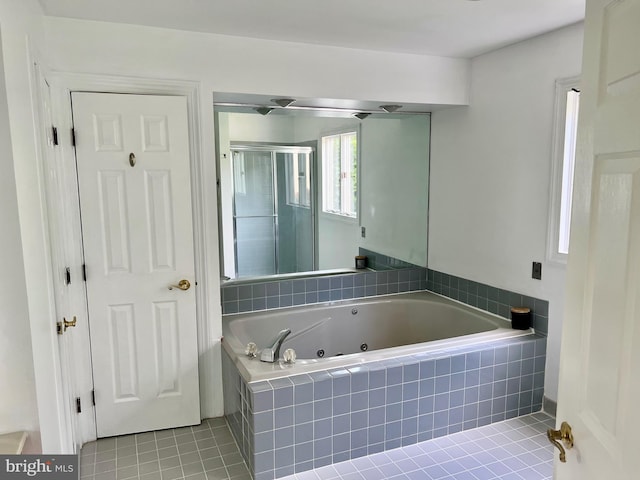 full bathroom with tile patterned flooring, a shower stall, and a tub with jets