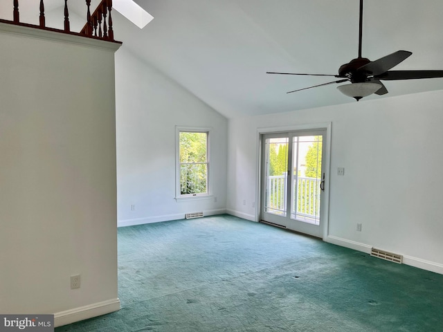 spare room with a skylight, visible vents, and carpet flooring