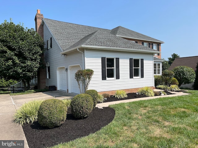 view of front of property with a garage, a shingled roof, driveway, a front lawn, and a chimney