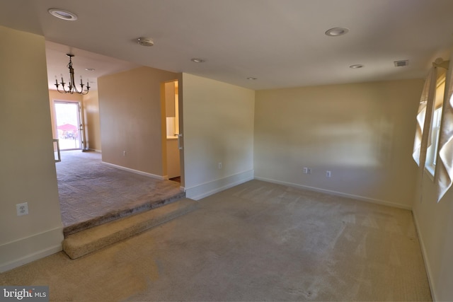 unfurnished room featuring carpet, baseboards, a notable chandelier, and recessed lighting