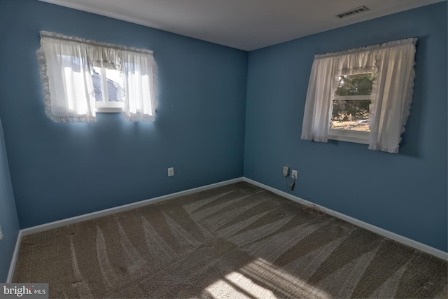 unfurnished room featuring carpet floors, baseboards, and visible vents