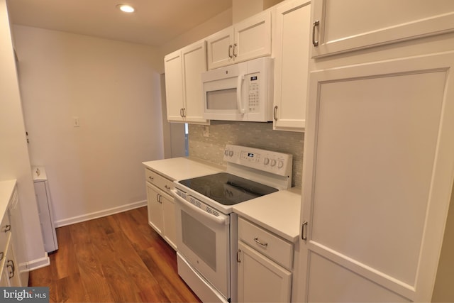 kitchen featuring white appliances, white cabinets, light countertops, backsplash, and dark wood finished floors