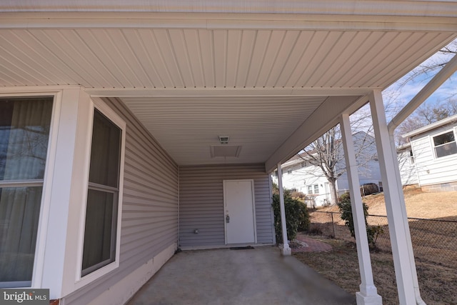 view of patio with fence and a carport