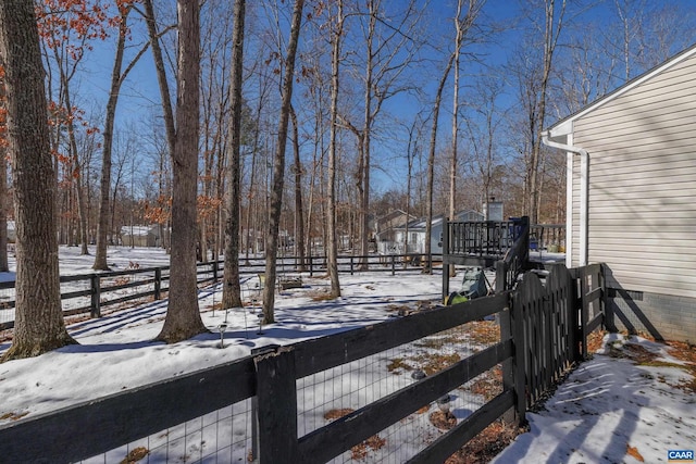 snowy yard with fence