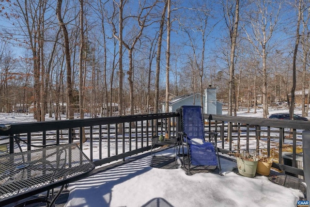 snow covered deck featuring cooling unit