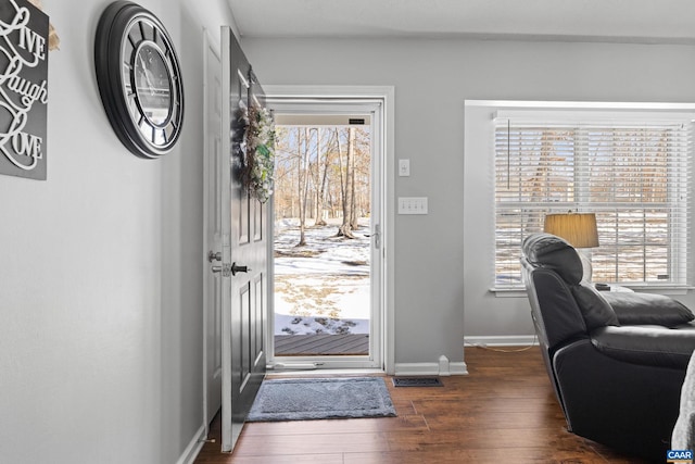 entryway with dark wood-type flooring, plenty of natural light, visible vents, and baseboards