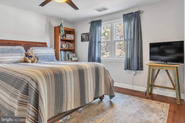 bedroom featuring a ceiling fan, baseboards, visible vents, and dark wood-type flooring