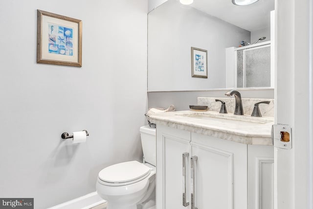 full bath with toilet, baseboards, and vanity